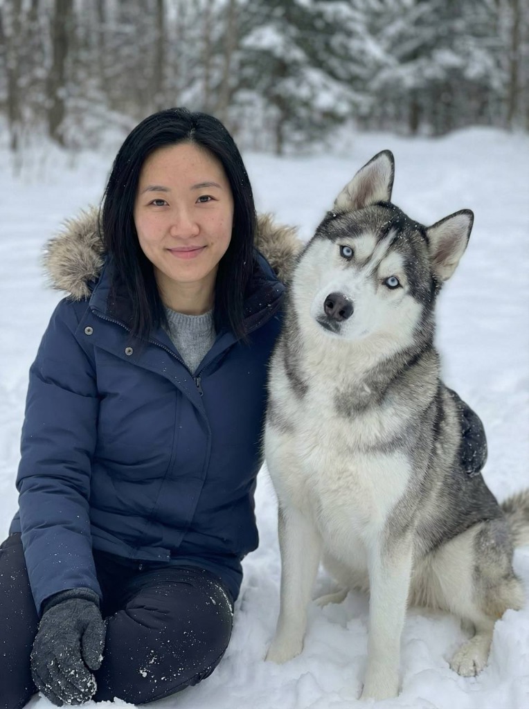 Person with husky in snowy forest