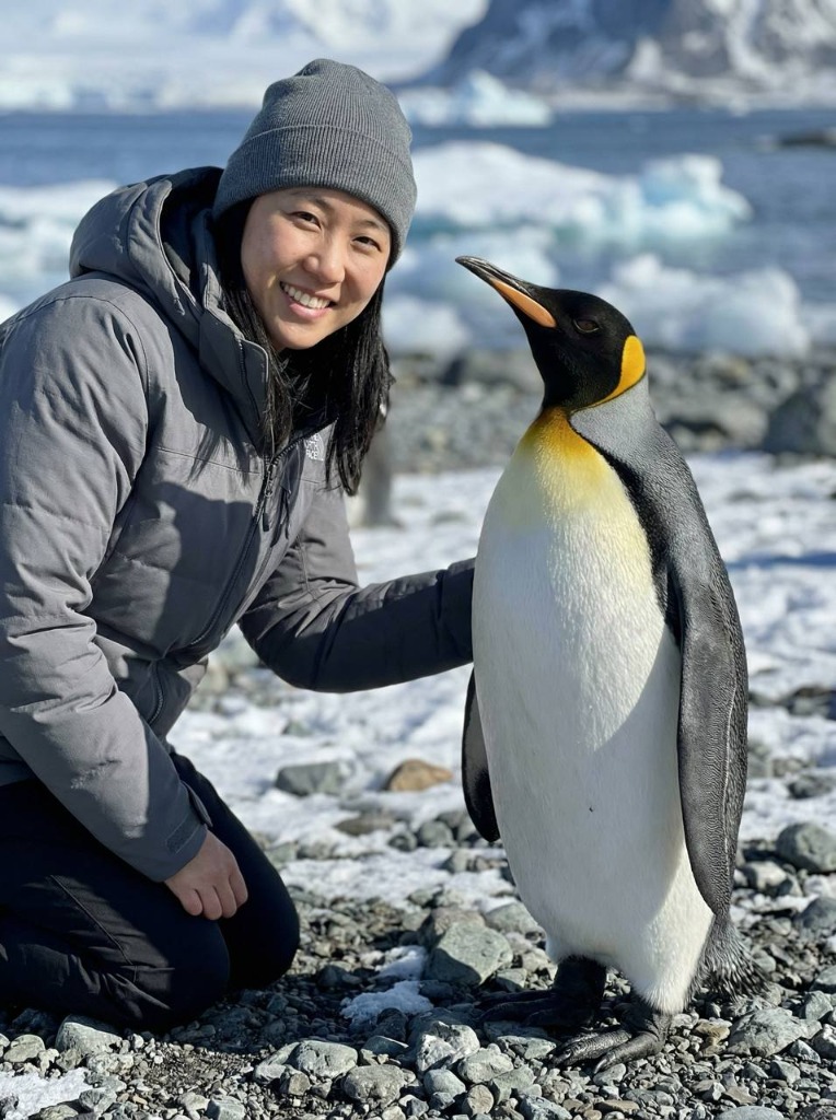 Person with penguin in Antarctica